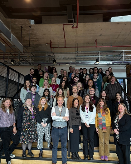 Careers service team standing on some steps in a building on campus